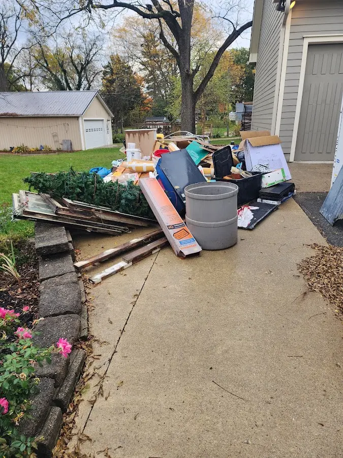 Dumpster being loaded with debris for 3 Yard Dumpster Rental in Mendota Heights